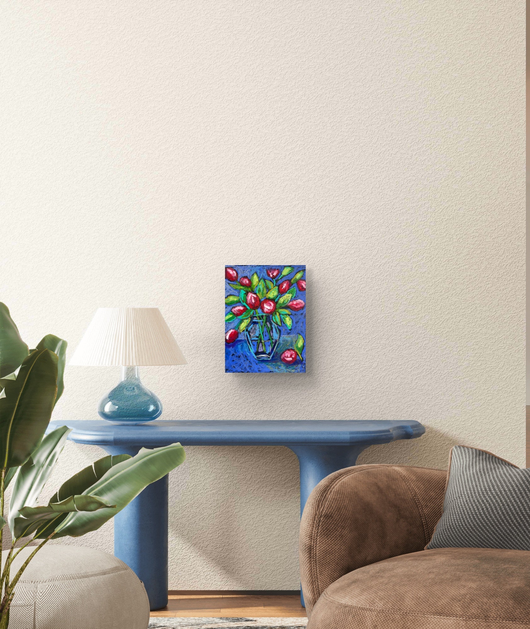 Colorful abstract painting on a wall above a blue table in a living room.