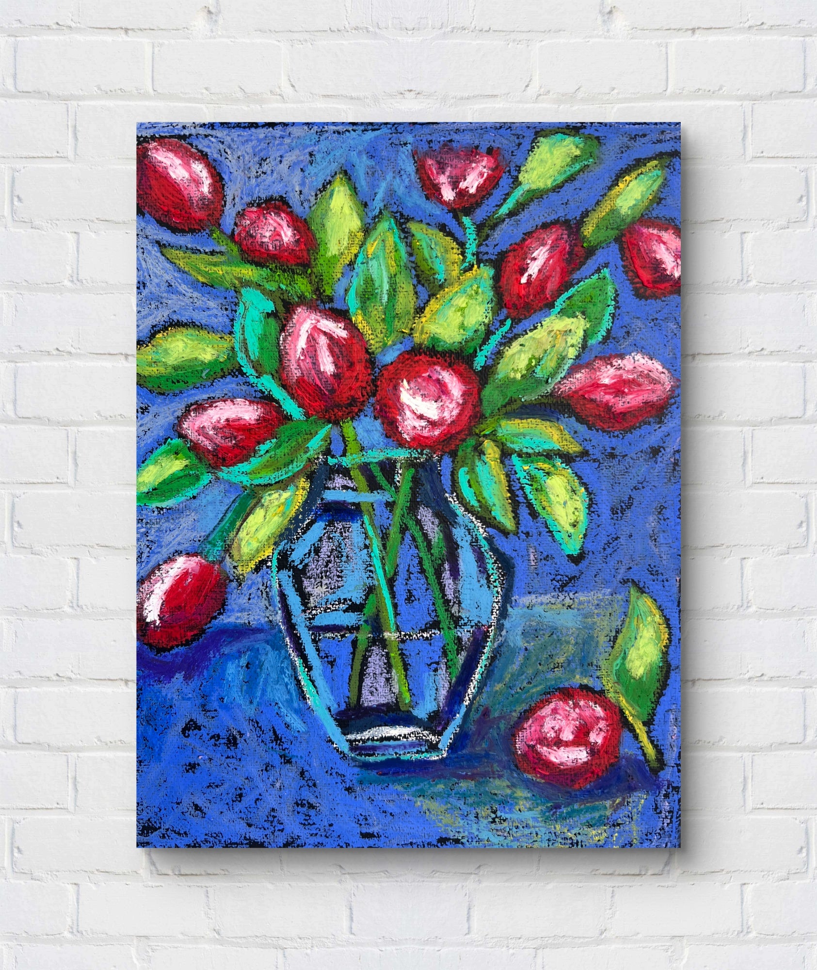 Colorful painting of a vase with red flowers on a white brick wall