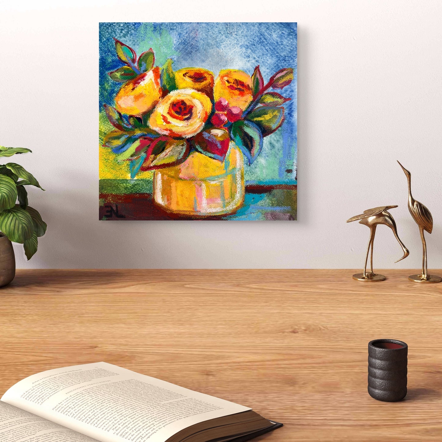 Colorful floral painting on a wall above a wooden surface with decor items.