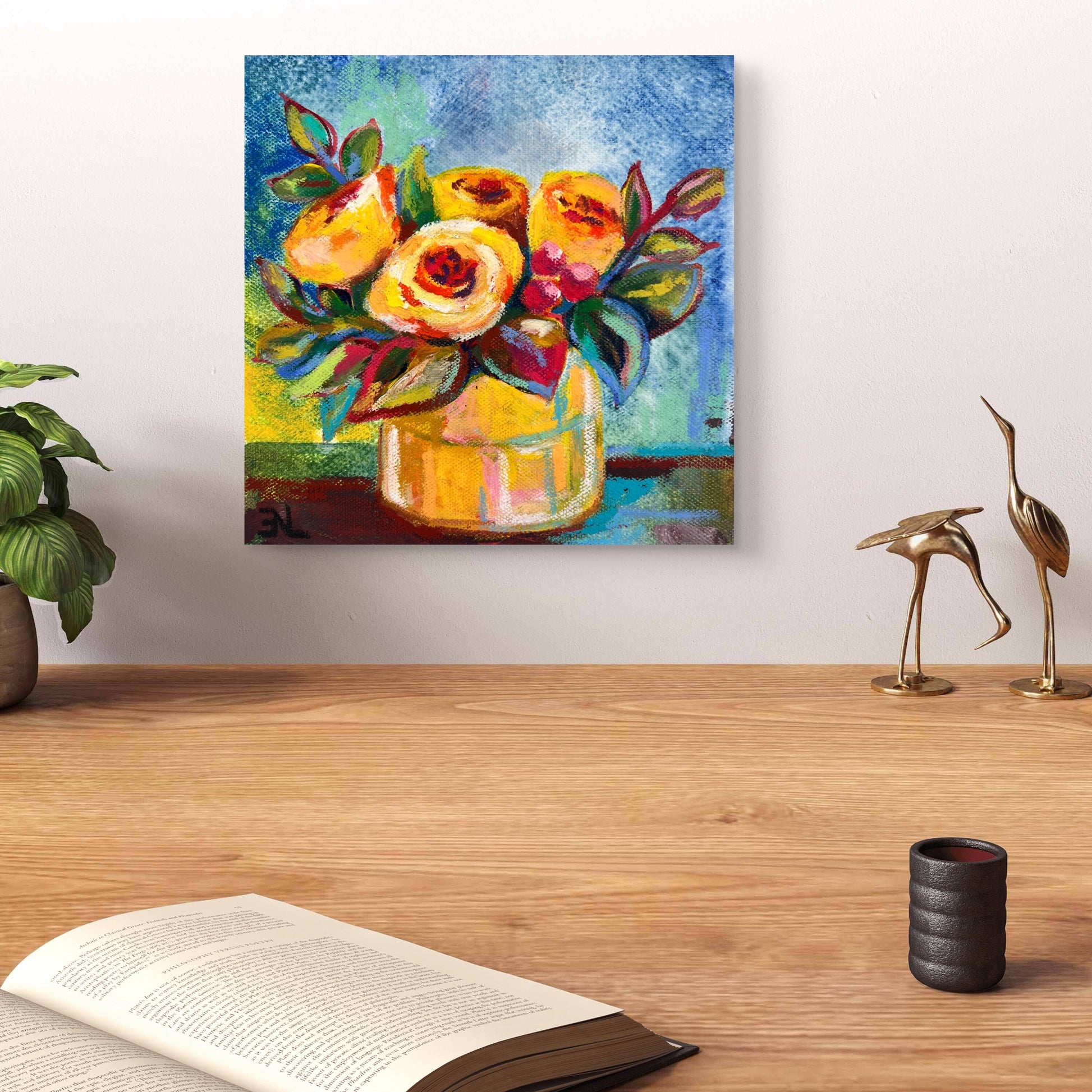 Colorful floral painting on a wall above a wooden surface with decor items.