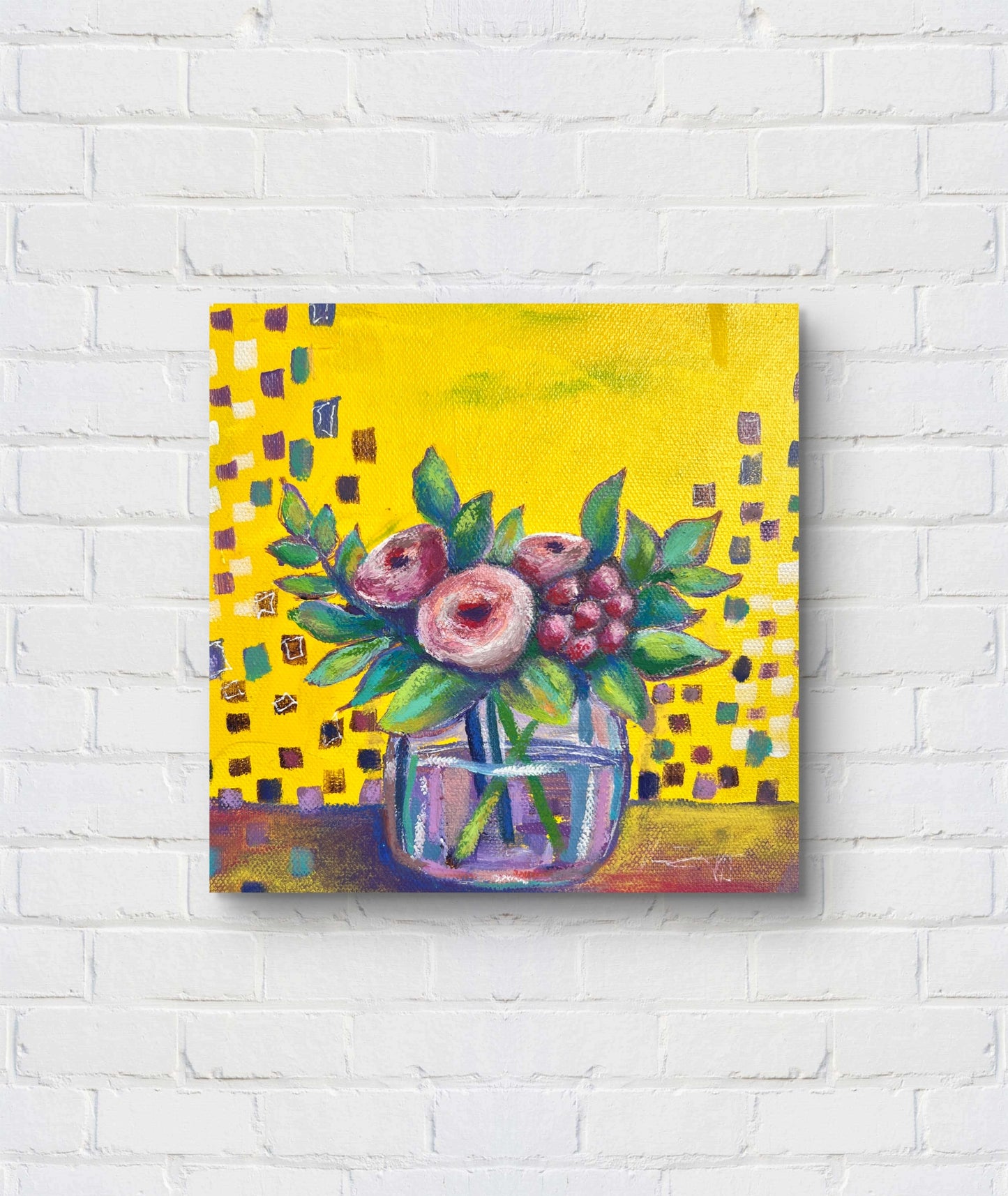 Painting of flowers in a glass jar on a yellow background, mounted on a white brick wall.