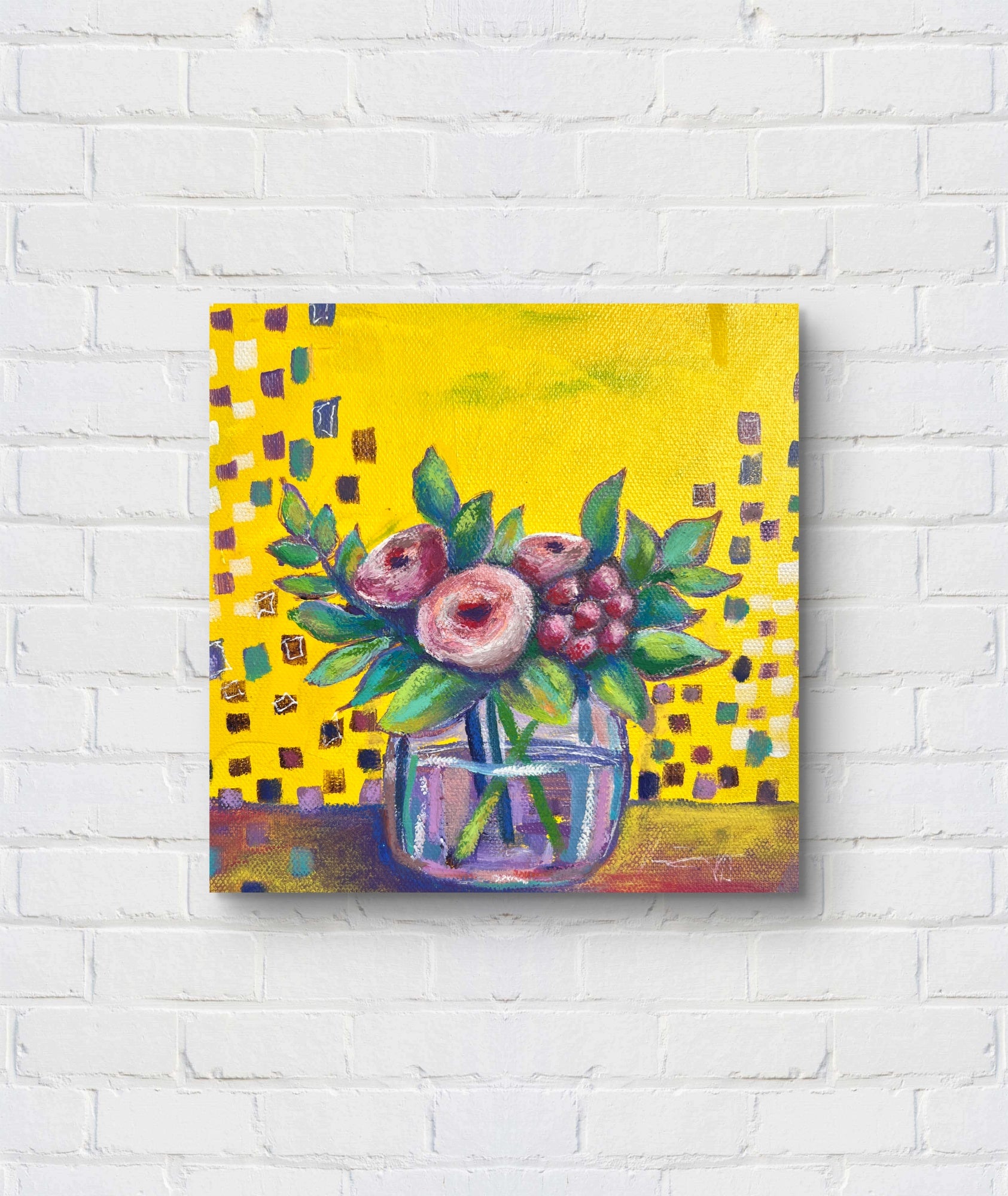 Painting of flowers in a glass jar on a yellow background, mounted on a white brick wall.
