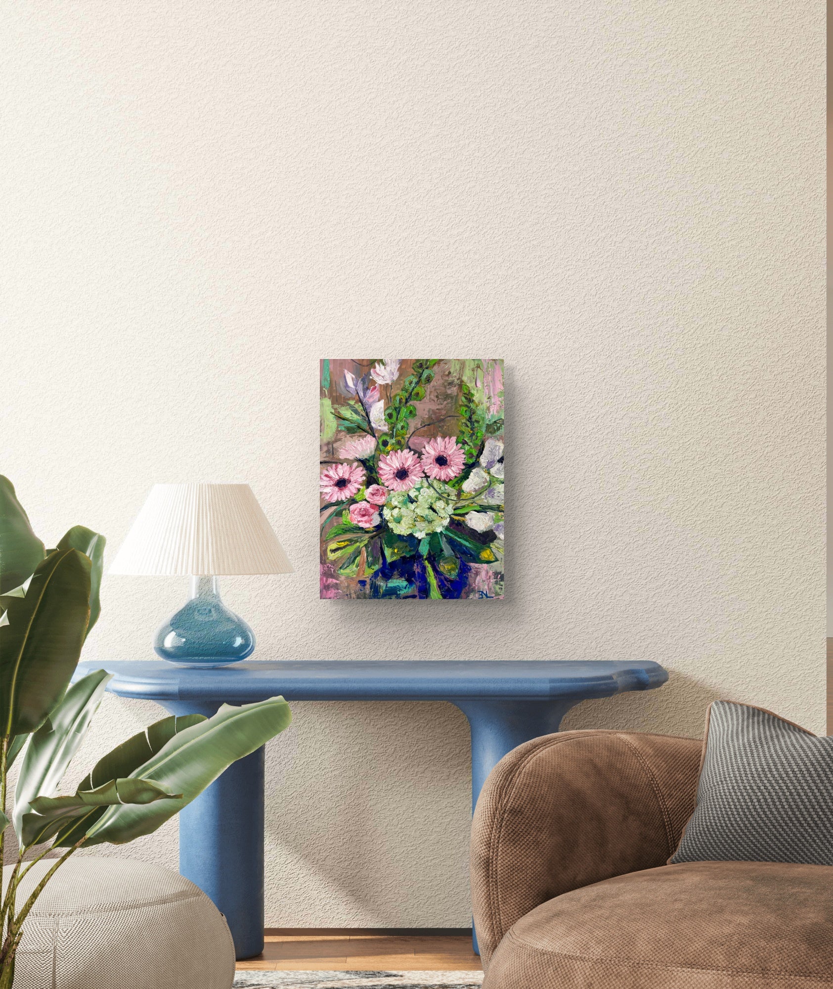 Floral painting on a wall above a blue table in a living room.